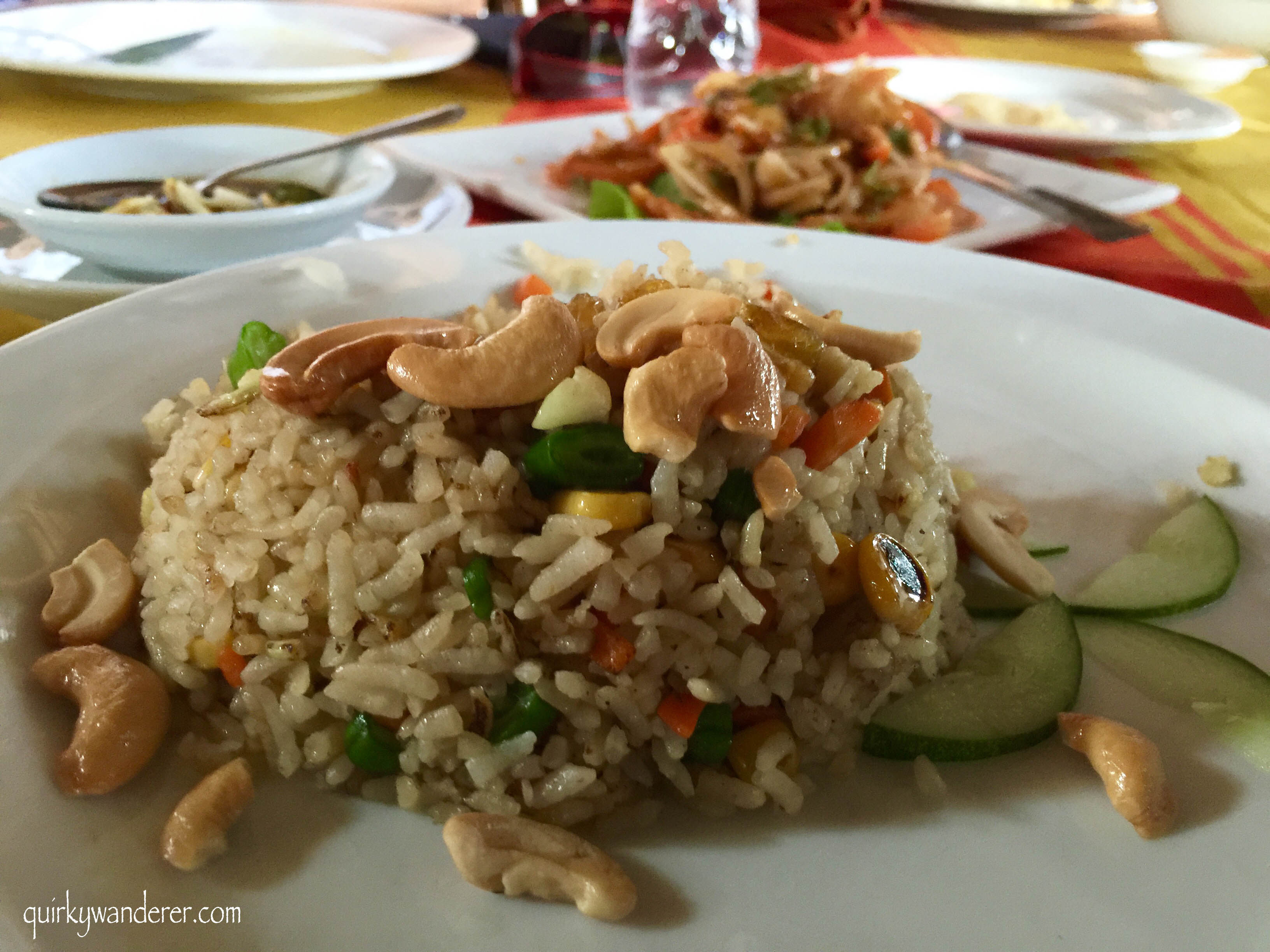 Vegetarian fried rice garnished with cashews and cucumber